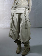 Victory jorts in beige from the Double Punch SS26 'Illusory Victory' collection. Flipped waistband design. Napoleon military jacket inspired double-breasted decorative buttons. Large side pockets. Baggy cargo shorts silhouette. Soft, comfortable 100% cotton fabric.